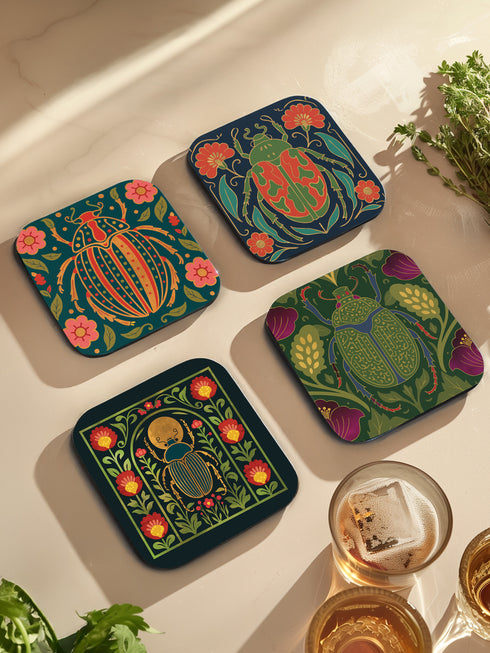 Set of 4 square Dark Academia Scarab Beetle Coasters, featuring detailed Gothic Botanical insect art prints in deep jewel tones. The hardboard coasters have a glossy finish and protective cork base. Premium Entomology Decor.